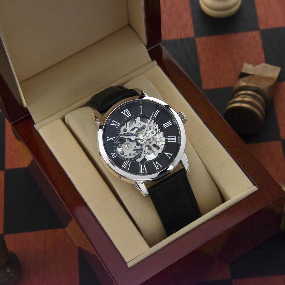 Luxurious openwork dial men's watch in a presentation box, showcasing intricate mechanical details and a classic Roman numeral face.