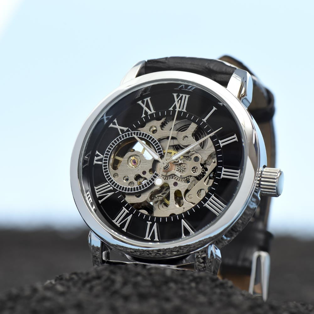 Luxurious openwork dial men's watch in a presentation box, showcasing intricate mechanical details and a classic Roman numeral face.
