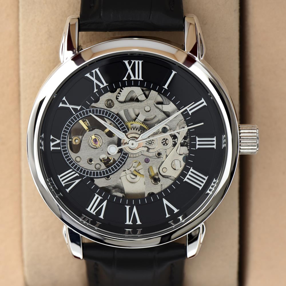 Luxurious openwork dial men's watch in a presentation box, showcasing intricate mechanical details and a classic Roman numeral face.