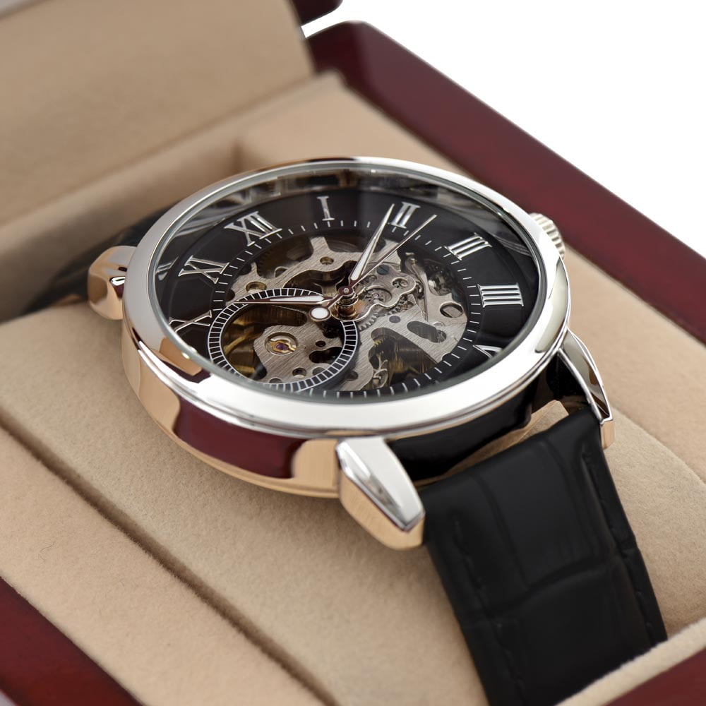 Luxurious openwork dial men's watch in a presentation box, showcasing intricate mechanical details and a classic Roman numeral face.